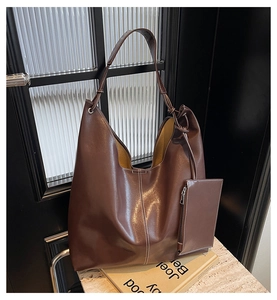 Detail view of large dark brown hobo tote bag with contrast stitching and inner pouch