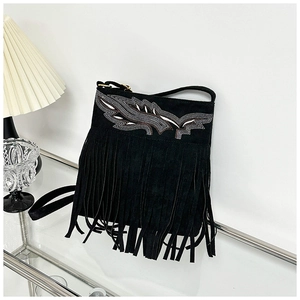 Detalle de bolso bandolera de ante negro con bordado de hojas y flecos densos