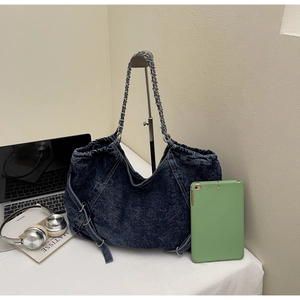 Spacious washed denim tote bag with chain strap shown with a tablet and laptop for capacity