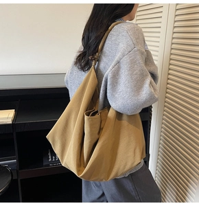 Detailed view of the ginger canvas shoulder bag featuring a unique knot handle design