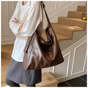 Deep brown oversized tote bag in vintage PU leather shown on model for size and style