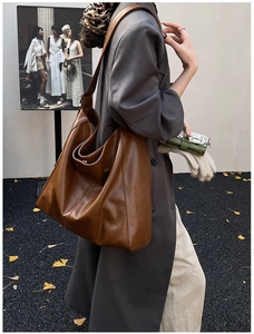 Detail view of retro brown tote bag in soft leather finish for daily commuting