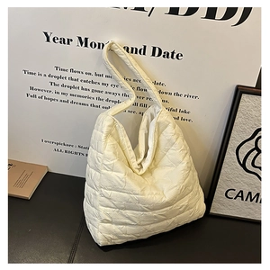 Detail of quilted texture and off-white fabric on this large commute tote bag