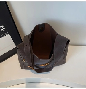 Top view of large dark taupe leather bucket bag showing magnetic closure and interior