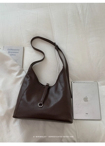 Détail du sac hobo vintage chocolat noir en cuir brillant avec boucle en métal argenté