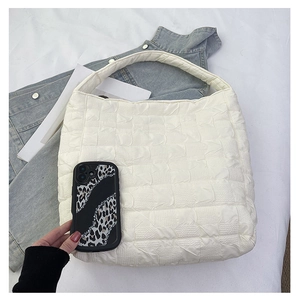 Detail showing the large-capacity pleated quilted fabric hobo bag with wide shoulder strap