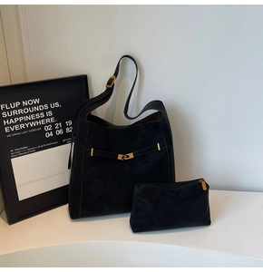 Detail of black suede hobo bag with gold adjustable buckle and matching zipper pouch
