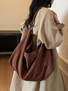 Brown canvas hobo shoulder bag with large capacity and elegant knot handle details