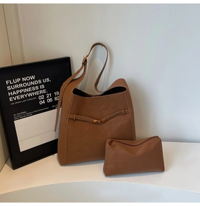 Detailed view of brown leather bucket tote bag set with matching inner pouch and metal buckle
