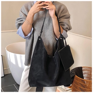 Detail of black large hobo bag with contrast stitching and small zippered pouch