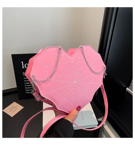 Detail der rosa herzförmigen Tasche mit Spinnennetznähten und glitzerndem Mitteldiamanten