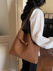 Large caramel leather bucket bag for women, chic commuting shoulder bag with strap