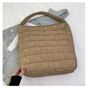 Detail of coffee brown quilted tote bag showing square stitching texture on fabric