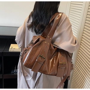 Detailed view of the vintage brown biker tote bag with wide eyelet shoulder strap