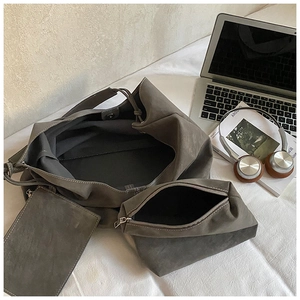 Three-piece dark grey matte leather tote set with large shoulder bag and small pouches