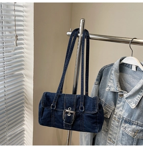 Détail du sac à bandoulière en denim bleu foncé avec boucle en métal rétro