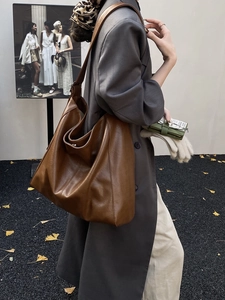 Brown leather hobo tote bag for women featuring a spacious minimalist commute design