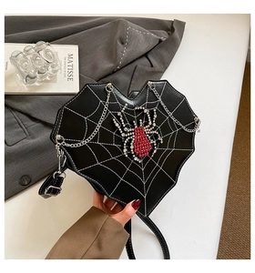 Detail der herzförmigen Spinnennetz-Tasche mit Strass-Spinne und silberner Kette