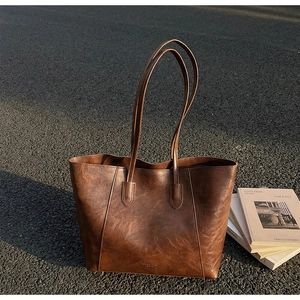 Close-up detail of the deep brown vintage tote bag with textured leather and stitching