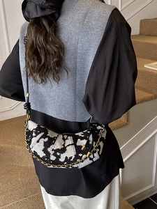 Chic black and white jacquard half-moon crossbody bag with gold chain and leather strap