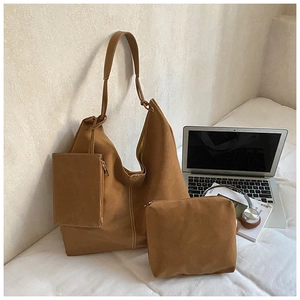Three-piece brown suede tote bag set with laptop and headphones for commute
