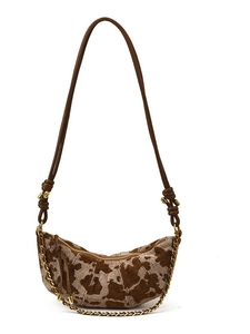 Chic cow-patterned half-moon shoulder bag with a vintage gold chain and adjustable strap