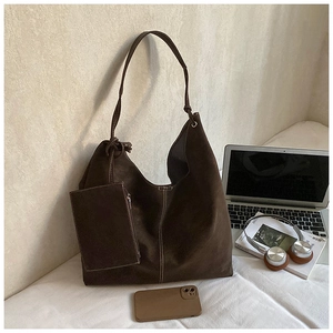 Macro shot of dark coffee suede tote bag with detachable pouch and visible stitching