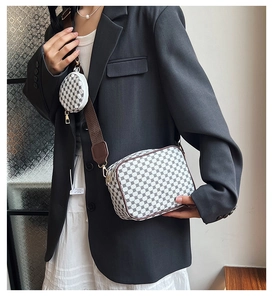 Detail of crossbody bag with geometric pattern, coin purse and wide shoulder strap