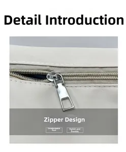Détail de la fermeture éclair en métal argenté et du nylon résistant du sac beige