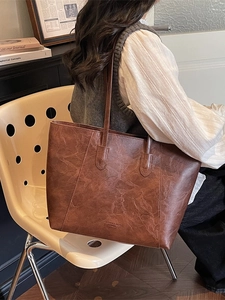 Brown vintage faux leather tote bag with pleated texture and stylish long straps