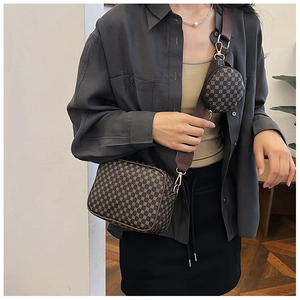 Detail of vintage square bag with circular coin pouch and wide woven shoulder strap