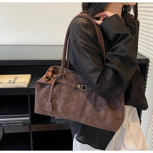 Vista lateral del bolso tote grande de gamuza marrón oscuro con correas delgadas