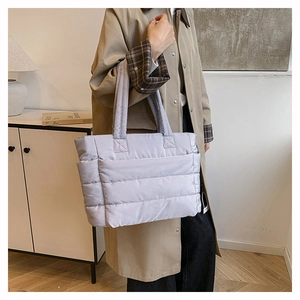 Detail showing the quilted texture and soft lavender nylon fabric of the large tote bag