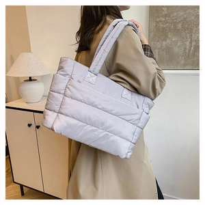 Detail of light purple quilted tote bag showing puffer texture and double shoulder straps