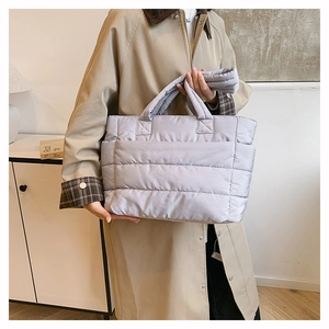 Close-up of a lightweight lavender quilted puffer tote bag with padded handles for women