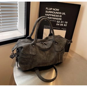Detail of dark grey vintage frosted tote bag with metal zipper and leather dual handles