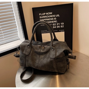 Macro shot of charcoal grey frosted faux leather boston bag with side buckle and zipper