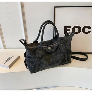Detailed view of retro frosted charcoal tote bag with metallic studs and dual straps
