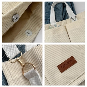 Detail view of corduroy tote bag showing magnetic closure, front pockets and metal hardware
