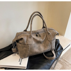 Detail of vintage tote bag featuring frosted texture, metal zippers, and sturdy handles