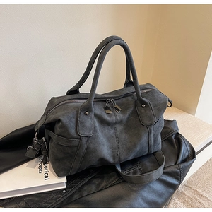 Detail of dark charcoal matte Boston bag with sturdy handles on a minimalist background
