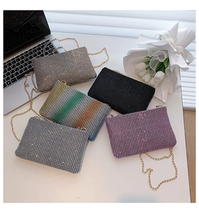 Macro view of crystal encrusted clutches in silver gold and pink with metal chains