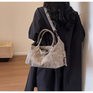 Close-up of vintage grey tote bag showing textured PU leather and metallic strap details