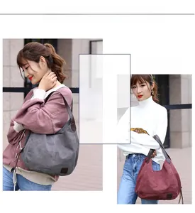 Detail showing the large capacity canvas tote bags in grey and burgundy with PU leather straps