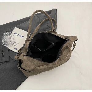 Overhead view of large brown vintage tote bag with interior lining and zipper pocket