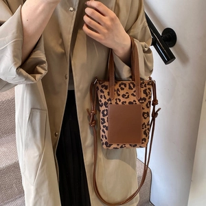 Vintage leopard print mini tote bag with brown leather pocket and adjustable shoulder strap