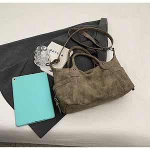 Detailed view of vintage matte tote bag with reinforced handles and adjustable strap