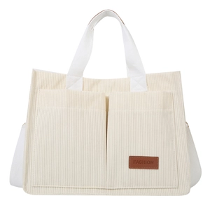 Minimalist beige corduroy tote bag with dual front pockets and adjustable shoulder strap