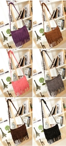 Detail of suede crossbody bags with long tassels and woven straps in six assorted colors