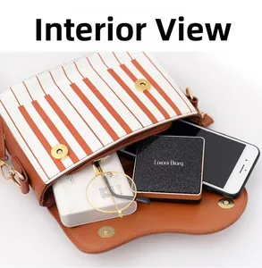 Macro view of the piano-style shoulder bag interior showing storage space and gold buckle